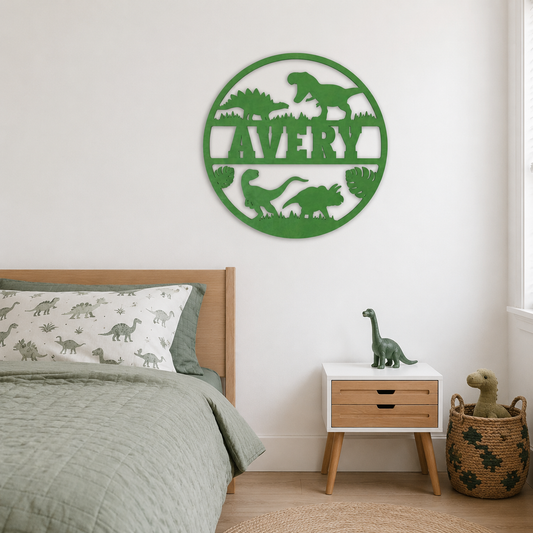 A green circular metal wall art piece featuring dinosaur silhouettes and the name 'AVERY' cut out, displayed on a white wall above a bed in a styled child's bedroom.